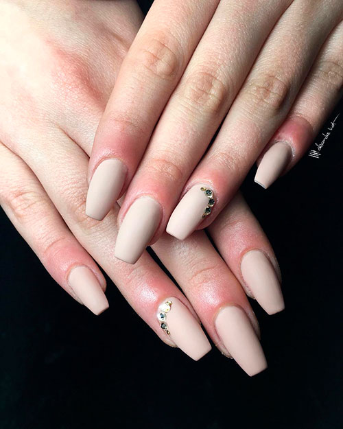 Matte nude coffin nails with gold rhinestones on accent nail!