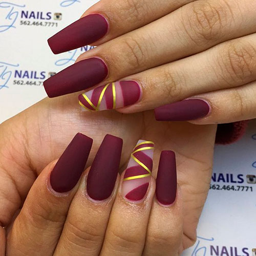 Cute matte burgundy coffin nails with gold striped accent nail!