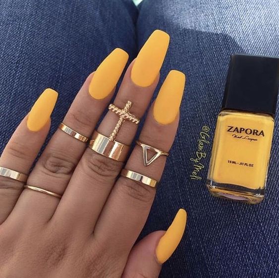 Gorgeous yellow acrylic nails coffin matte long set with gold rings for women on hand