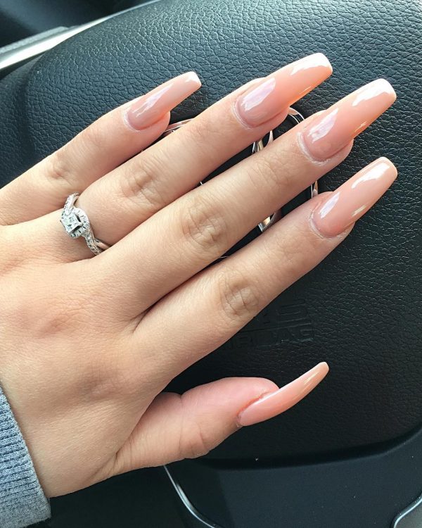 nude coffin nails long set with stunning ring on ring fingernail