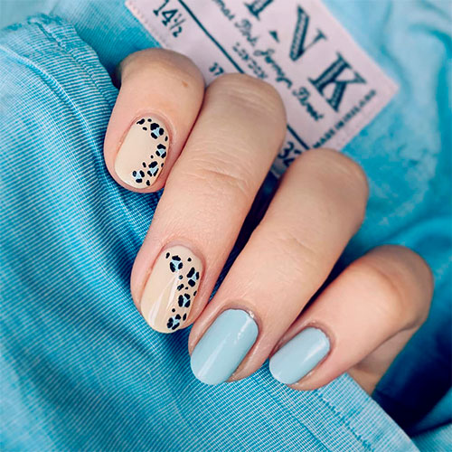Amazing blue leopard print nails on nude nails with two pastel blue nails
