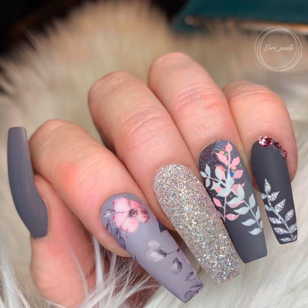 spring nails 2019 design consist of light to medium gray long coffin floral nails, and an accent silver glitter nail