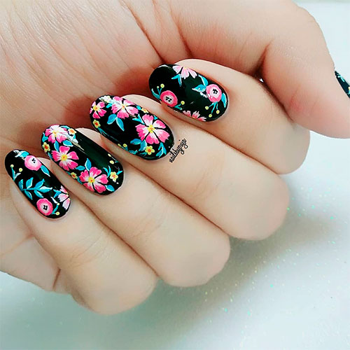 Cute pink and yellow floral round shaped nails with a black base coat