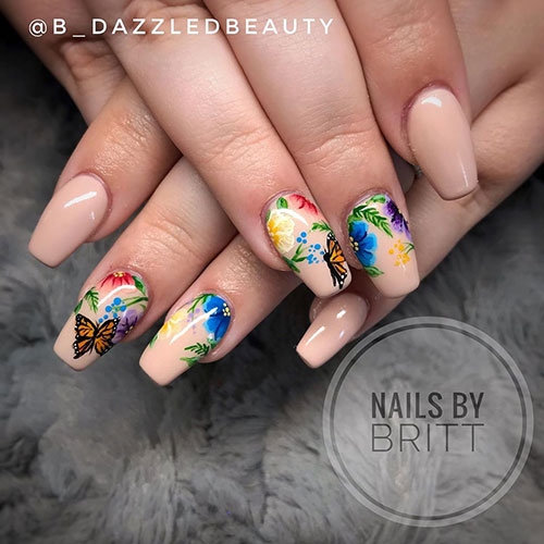 cute nail art that mixes between butterfly nails and floral nails on a nude coffin shaped nails
