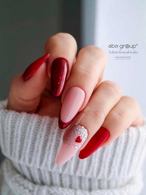 Long almond-shaped red and pink valentines nails 2023 with rhinestones and a heart shape