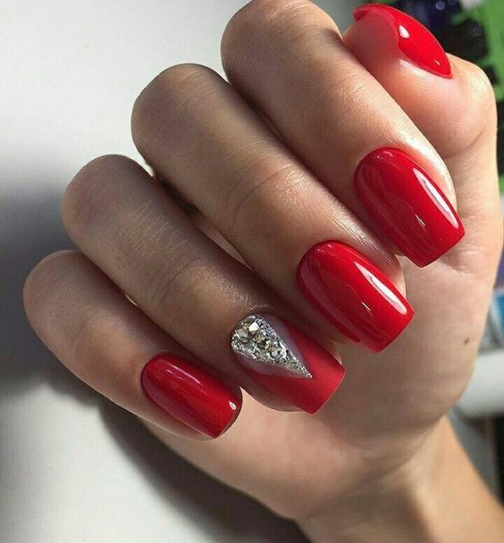 Red nails and an accent matte red nail with large rhinestones, Red and Silver Nails