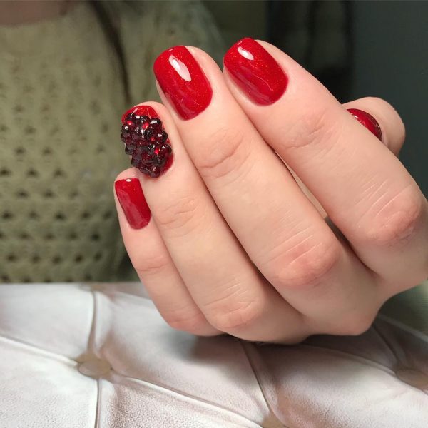 Red nails and an accent red nail with amazing black rhinestones Credit: Red nails and an accent red nail with amazing black rhinestones