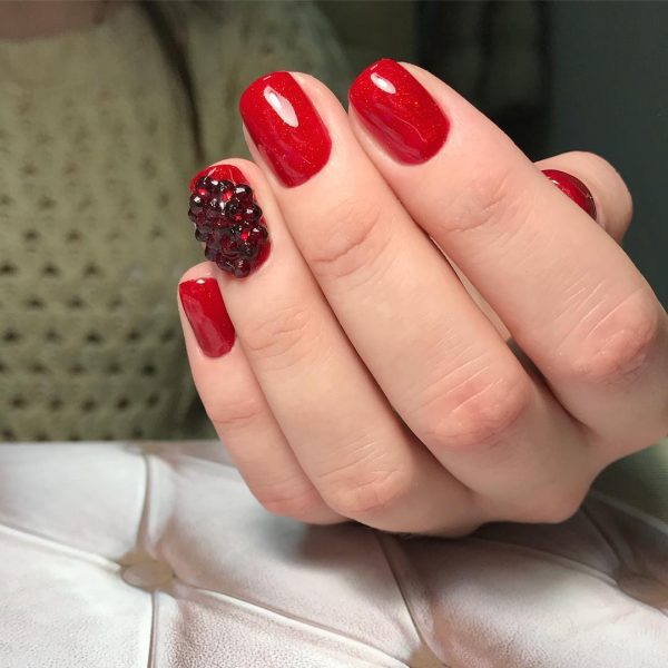 Credit: Red nails and an accent red nail with amazing black rhinestones