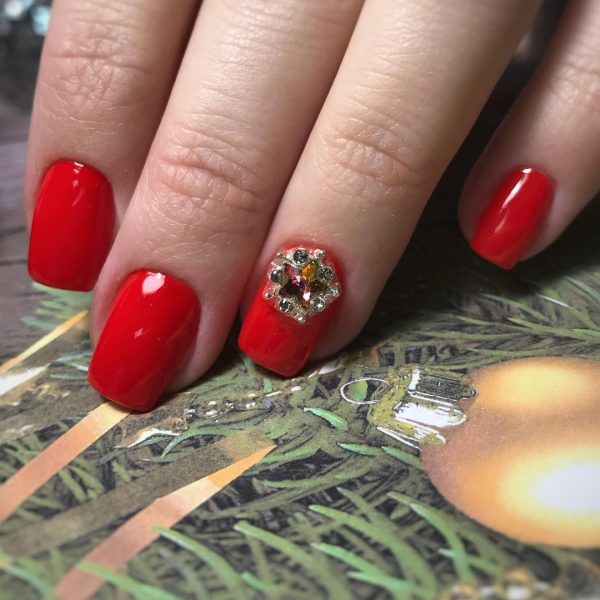 Red nails and an accent red nail with amazing rhinestones