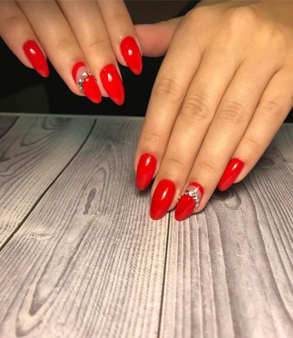 Red nails and an accent red nail with beautiful rhinestones Red nails and an accent red nail with beautiful rhinestones