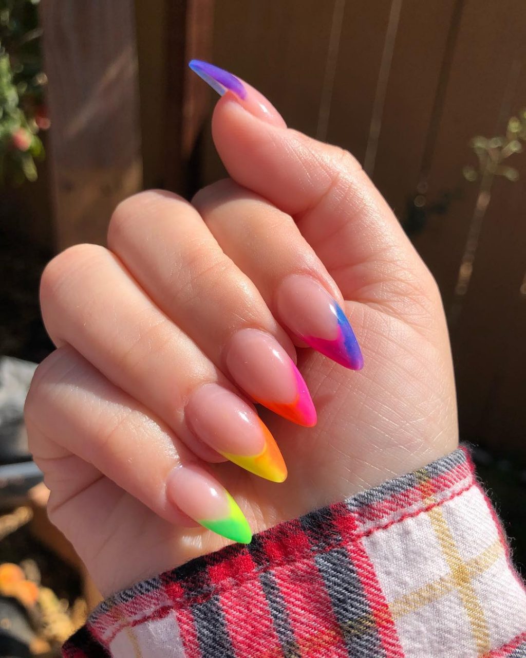 Amazing Rainbow French Tip nails on almond-shaped nails