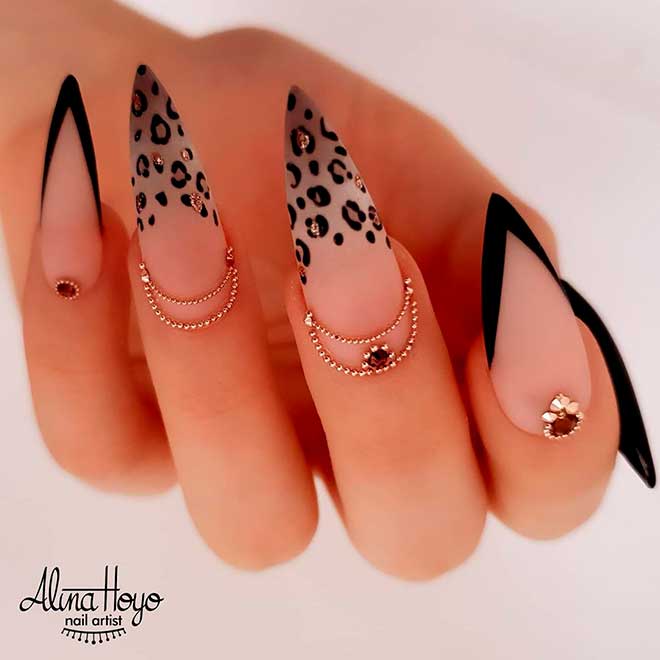 Stiletto black French tip nails with two accent leopard stiletto nails with gold rhinestones design!