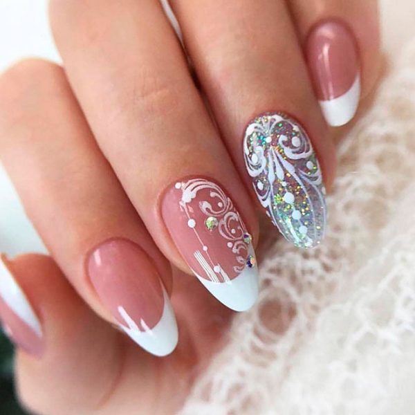 Cute White French tip nails with an accent glitter nail and decorative white hand paintings