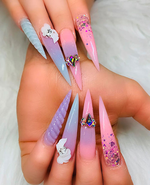Cute long stiletto unicorn nails adorned with glitter and crystals!