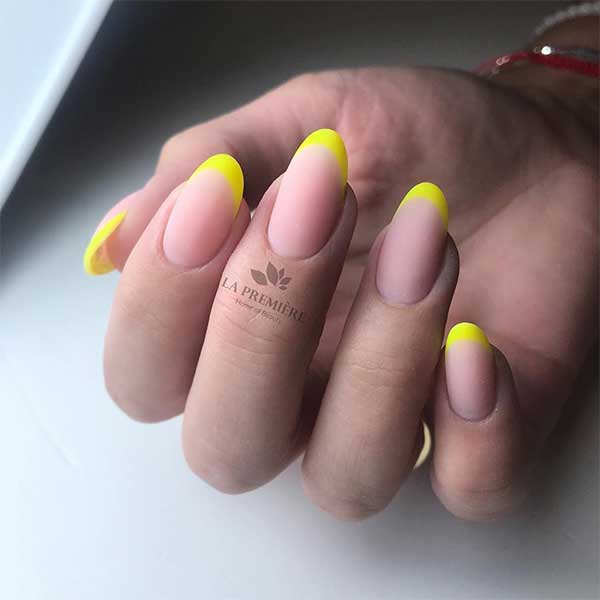 Cute and trendy matte neon yellow French tip nails