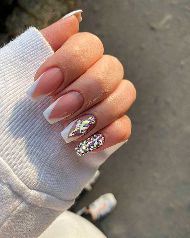 Cute modern coffin shaped French tip nails set with white tips and rhinestones!