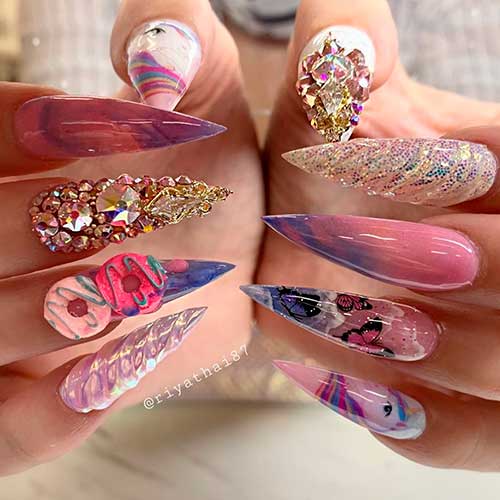 Cute stiletto unicorn nail art with rhinestones and glitter!