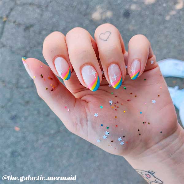 Pretty rainbow french tip nails design with white stars