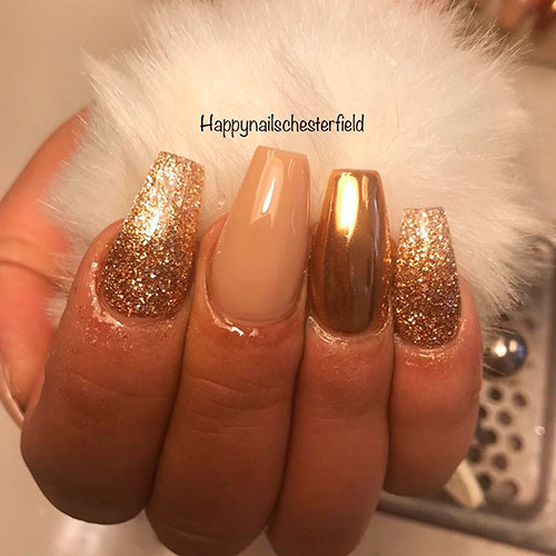 Cute gold chrome coffin nails, nude nail, and two gold glitter nails