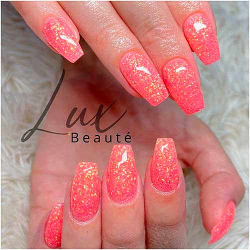 Coffin shaped coral color nails with glitter