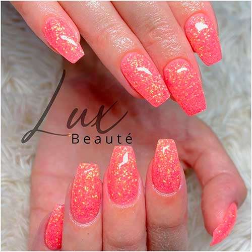 Coffin shaped coral color nails with glitter Coffin shaped coral color nails with glitter