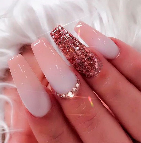 Cute pink and white ombre coffin nails with an accent glitter nail and gold rhinestones on middle fingernail!