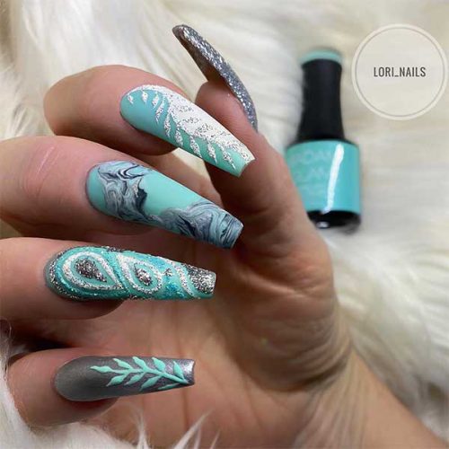 Cute turquoise matte coffin nails with glitter design!