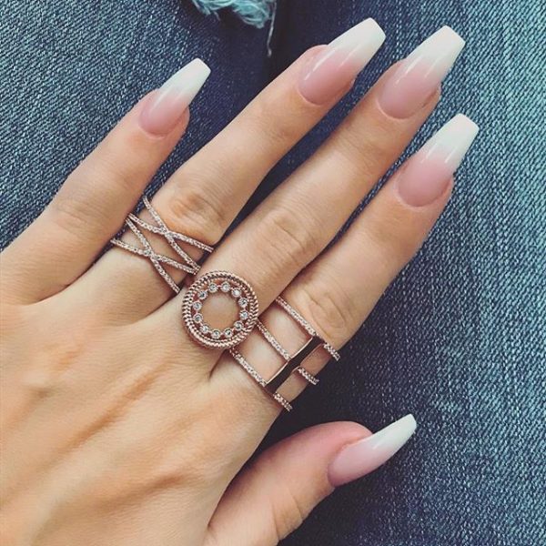 Elegant pink and white ombre coffin nails with cute rings for women