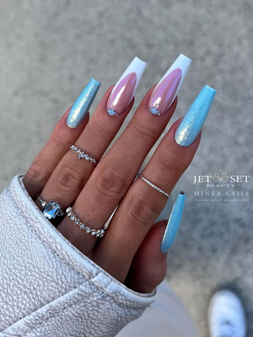Glitter light blue coffin nails with two accent white French tip nails adorned with tiny light blue flower and rhinestones Glitter light blue coffin nails with two accent white French tip nails adorned with tiny light blue flower and rhinestones