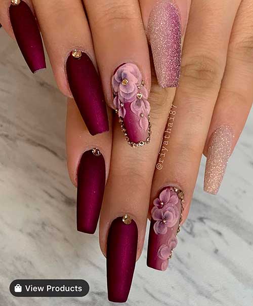 Gorgeous burgundy coffin shaped nails with glitter, gold rhinestones, and accent floral nail!