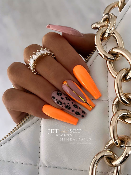 Long coffin orange nails with two accent nude nails one of them adorned with cheetah prints Long coffin orange nails with two accent nude nails one of them adorned with cheetah prints