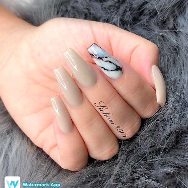 Pretty coffin shaped nude nails set with an accent marble nail!