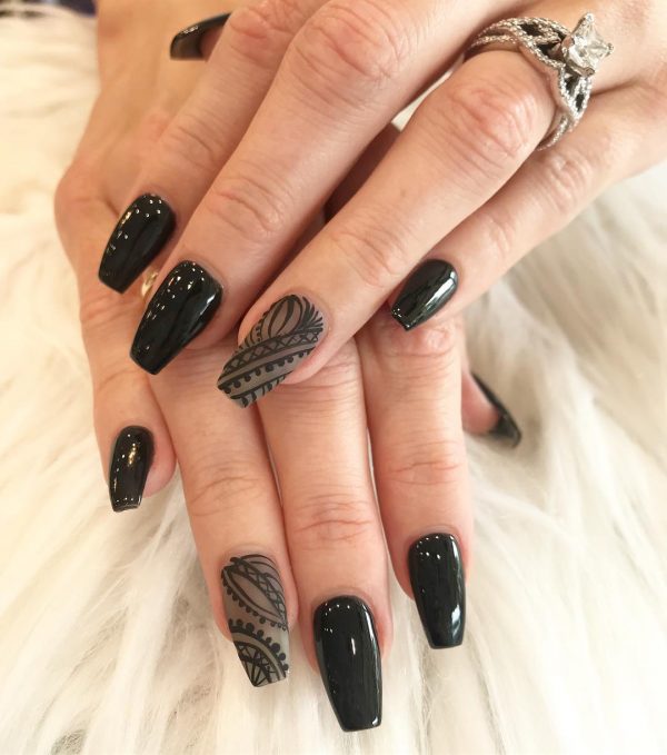 Stylish black coffin nail art design with black matte decorative lines on accent nude nail!