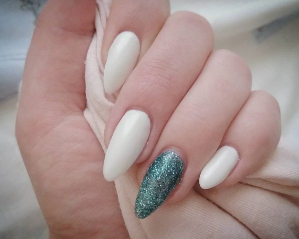 Stunning white nails with accent blue glittery nails! Stunning almond white nails with accent teal blue glittery nails