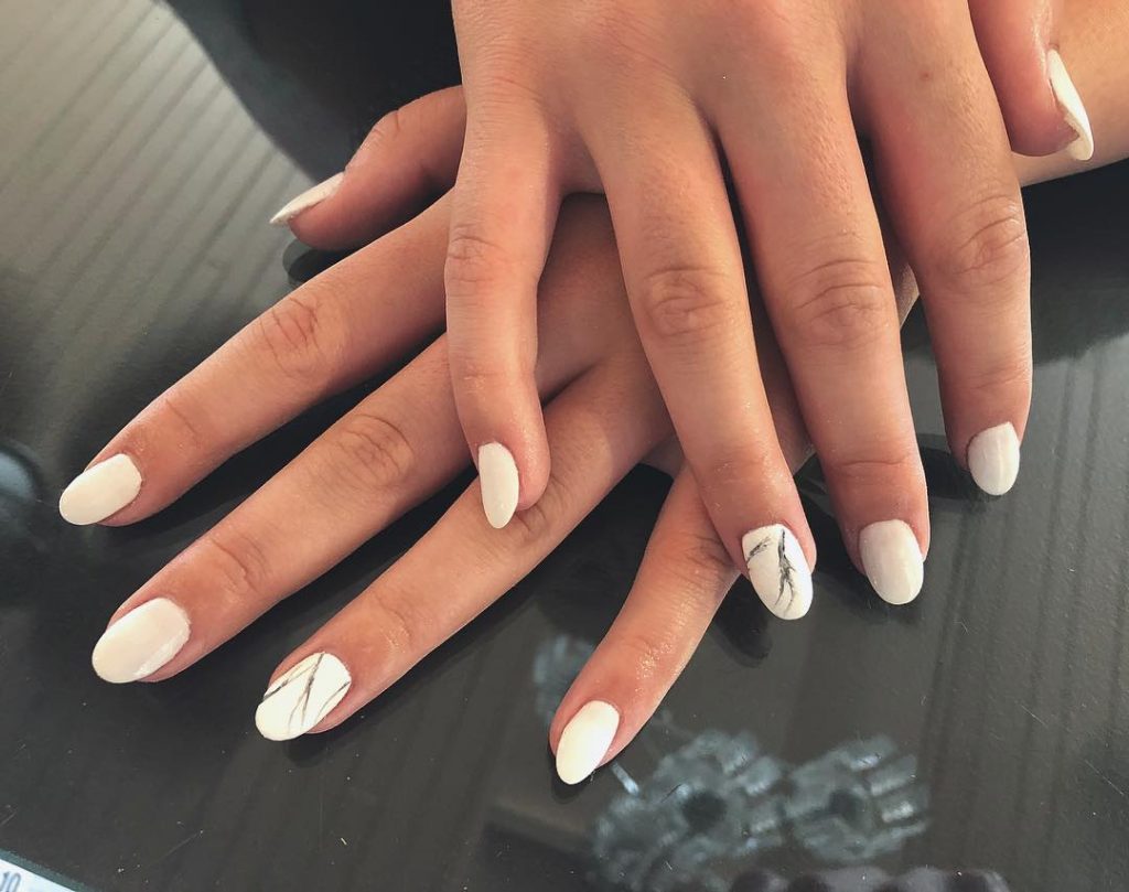 Gorgeous short white acrylic nails with accent marble nail! 