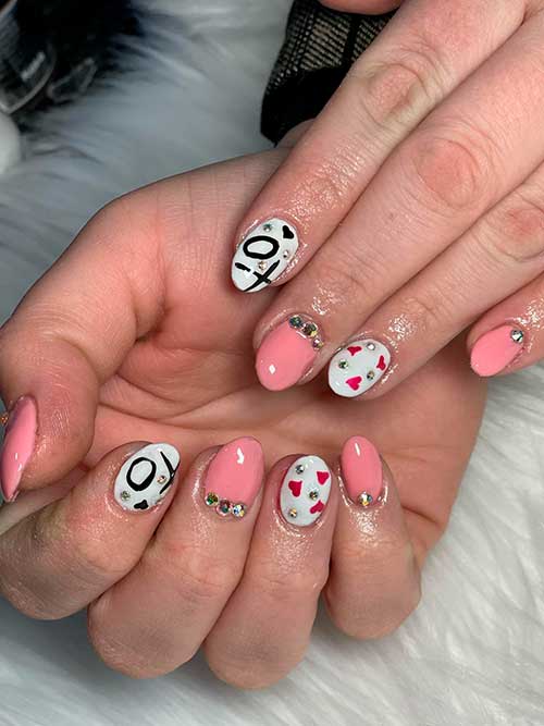 Short Round White and Nude Pink Valentine Acrylic Nails 2023 with Rhinestones, XO, and Red and Black Hearts
