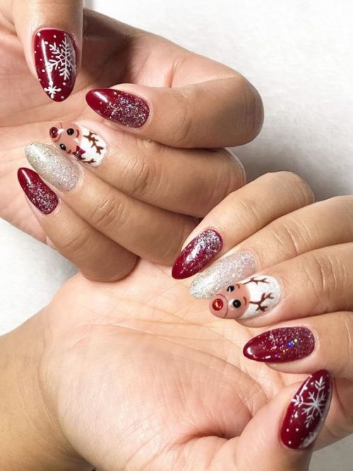 Amazing Christmas nails with glitter, snowflakes, and Reindeer accent nail!