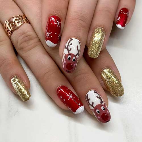 Beautiful red Christmas nails with gold glitter nails and an accent reindeer nail design!