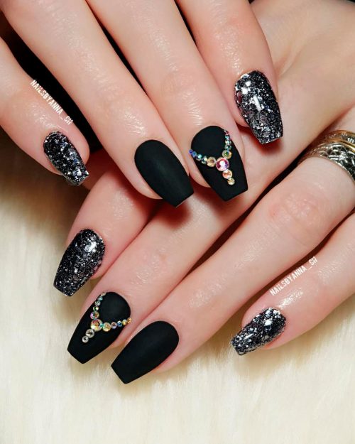 Amazing matte black coffin nails with rhinestones and two silver glitter nails!