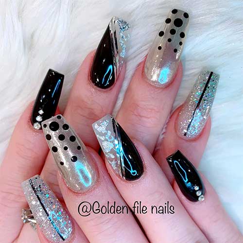 Black coffin shaped nails with silver nails and adorned with silver glitter, silver foil, and rhinestones!