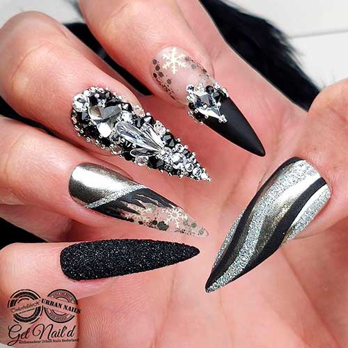 Gorgeous long black and silver nails with two accent glitter and bling nails