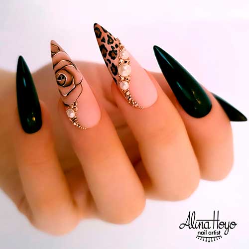 Cute black stiletto nails with rhinestones, accent leopard stiletto nail, and flower accent nail design! 
