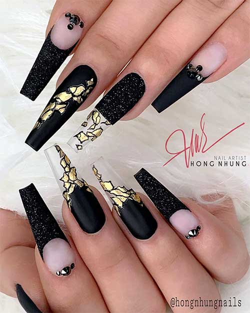 Cute long coffin shaped black nails with black glitter, rhinestones,and gold foil design!