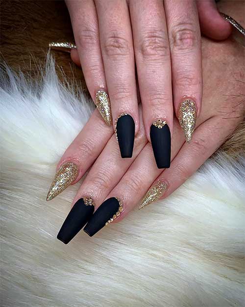 Cute matte black coffin nails with gold glitter on stiletto nails design!