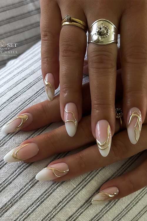 Elegant French ombre nails blend soft nude and white tips, featuring 3D chrome gold accents for a sophisticated look. Elegant French ombre nails blend soft nude and white tips, featuring 3D chrome gold accents for a sophisticated look.