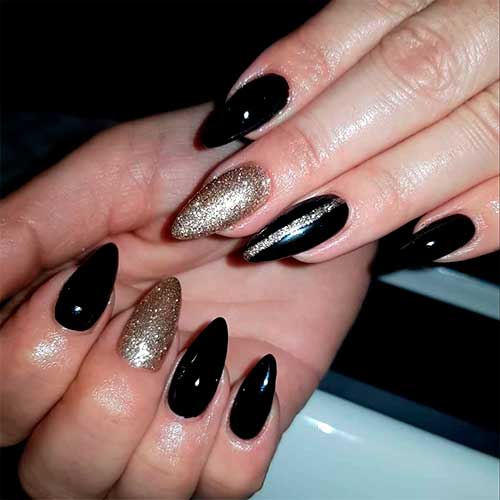 Elegant black almond nails with an accent gold glitter nail design!