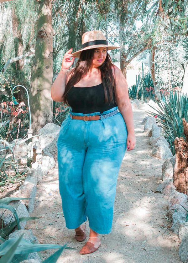 Perfect outfit look for plus size women consists of hat, black top, and blue pants!