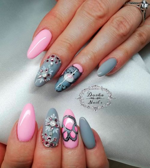 Pink and grey almond nails with some cute crystals forming a snowflake