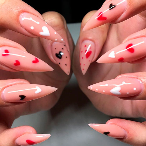 Amazing nude stiletto nails with black, white, and red hearts for valentine's day!