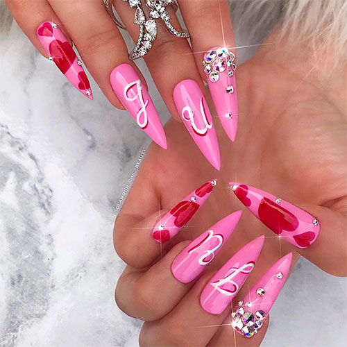 Amazing valentines pink stiletto nails adorned with some crystals
